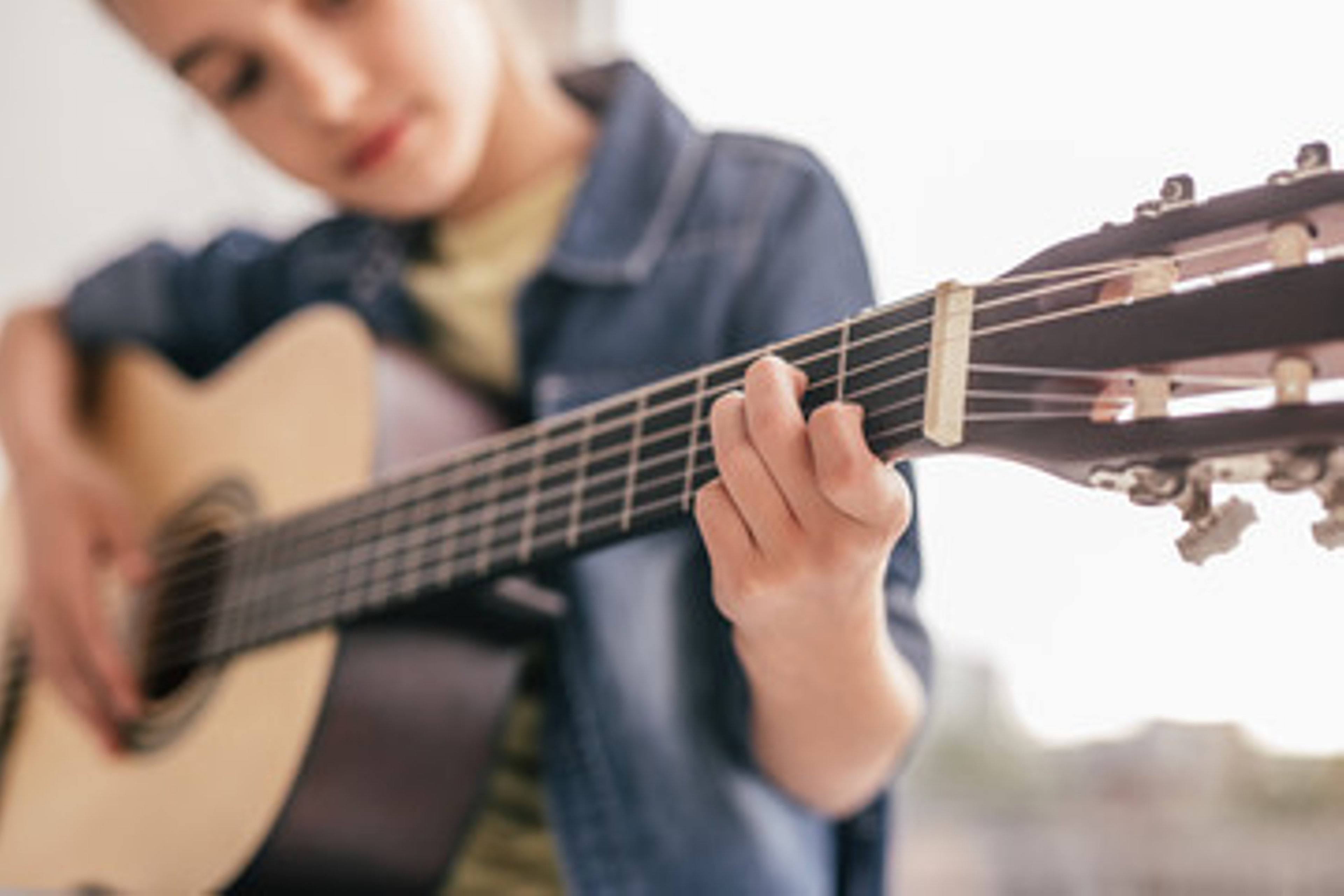 Child learning to play guitar