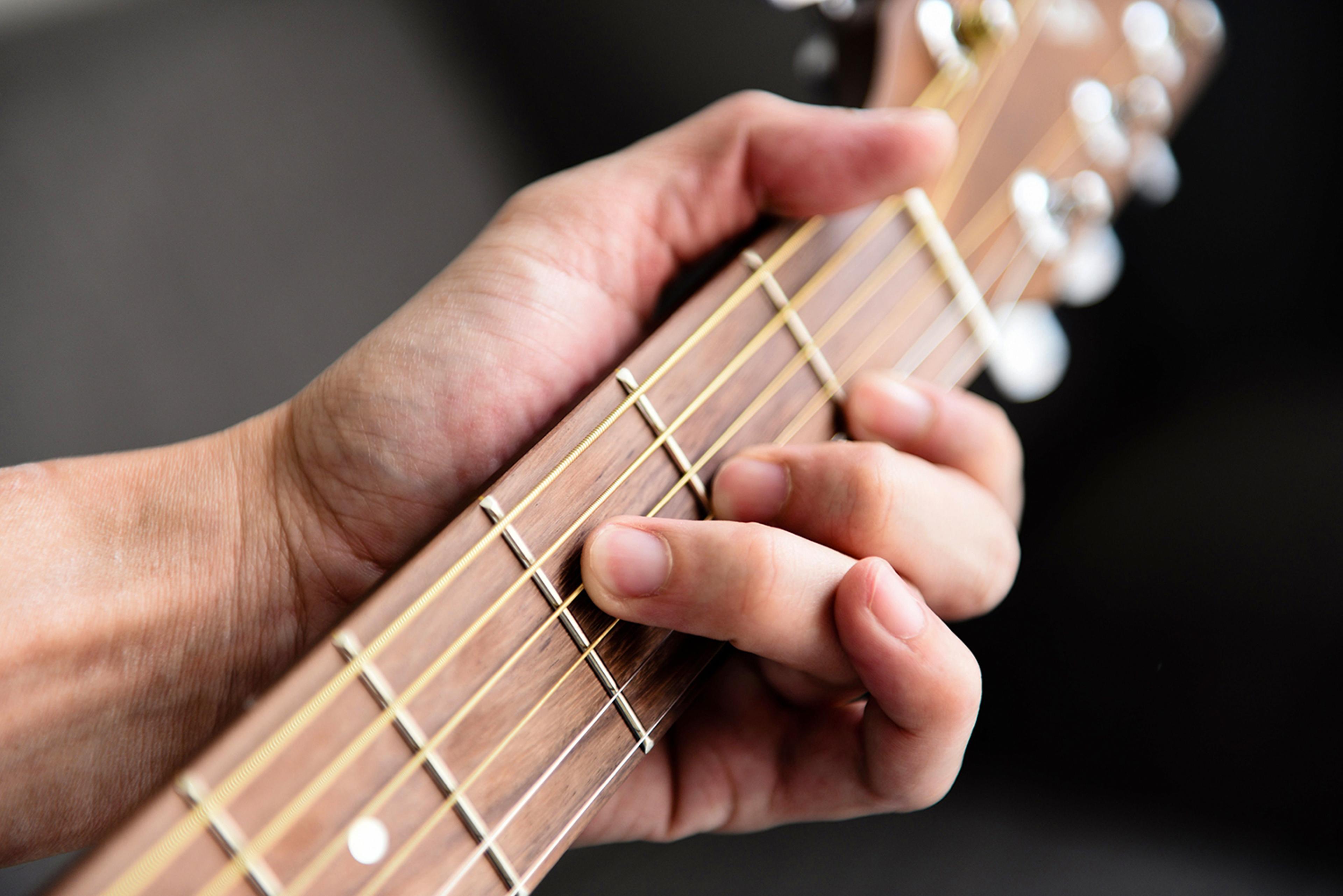 Happy kid playing guitar